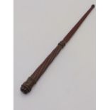 A 19TH CENTURY CARVED MAHOGANY BATON OF SHORT STAFF WITH REEDED DECORATION AND CARVED MONOGRAM, E.