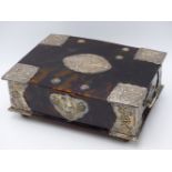 A HEAVILY STYLIZED WHITE METAL FLORAL REPOUSSE GENEROUSLY MOUNTED TORTOISE SHELL BOX. (WIDTH