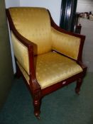 A COLONIAL CARVED HARDWOOD 19TH.C. ARMCHAIR IN THE REGENCY STYLE WITH BRASS CASTORS.