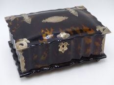 A FLUTED AND DOMED TORTOISE SHELL HINGED BOX WITH WHITE METAL BOUND CORNERS AND NAME PLATES. (