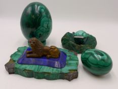 AN ANTIQUE POLISHED MALACHITE "EGG" AND SMALLER SIMILAR EXAMPLE AND A SPHERE ON STAND TOGETHER