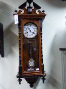 A LATE VICTORIAN VIENNA TYPE WALL CLOCK WITH TWO PART ENAMEL DIAL AND STRIKING MOVEMENT BY