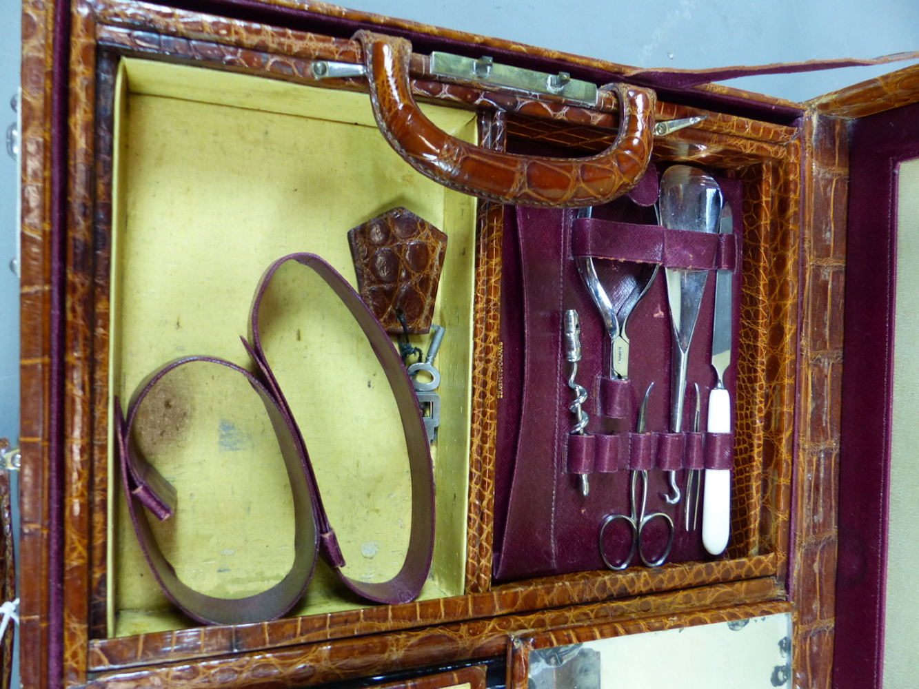 AN EARLY 20TH CENTURY CROCODILE LEATHER TRAVELLING VANITY CASE. PART FITTED WITH VARIOUS WHITE METAL - Image 4 of 14