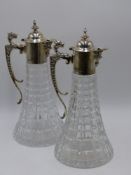 A PAIR OF SILVER MOUNTED CUT GLASS CLARET JUGS, HALLMARKED SHEFFIELD, CIRCA 1991. 30CMS HIGH.