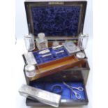 A ROSE WOOD AND BRASS INLAID DRESSING CASE FITTED WITH VARIOUS GLASS AND WHITE METAL TOPPED JARS AND