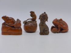 FOUR FINELY CARVED HARDWOOD FIGURAL NETSUKES.