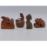 FOUR FINELY CARVED HARDWOOD FIGURAL NETSUKES.