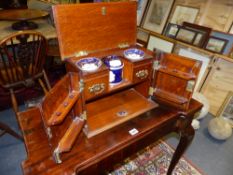 A CARVED OAK EDWARDIAN SMOKER'S CABINET WITH FITTED INTERIOR AND BRASS CARRYING HANDLES.