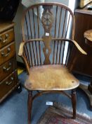 A 19TH.C.YEW WOOD AND ELM WINDSOR ARMCHAIR WITH CRINOLINE STRETCHER.