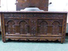 AN 18TH.C.AND LATER CARVED OAK COFFER WITH ARCH PANEL FRONT. 123CMS WIDE.