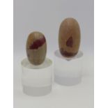 TWO INDIAN SHIVA LINGAM STONES OF BROWNISH GREY COLOUR WITH RED INCLUSION, LARGEST 11CM BOTH NOW