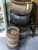 A COLLECTION OF SEVEN ANTIQUE CAST IRON COOKING CAULDRONS OF VARIOUS SIZES.