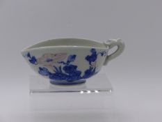 A BLUE AND WHITE EXPORT POURING VESSEL OF UNUSUAL FORM WITH FLOWER HEAD DECORATION, DRAGON HANDLE