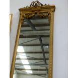 AN IMPRESSIVE PAIR OF TALL GILT FRAMED FRENCH STYLE HALL MIRRORS WITH FLORAL SWAG DECORATION. APPROX