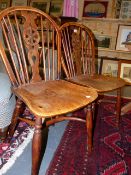 A SET OF FOUR ANTIQUE YEW WOOD AND ELM WHEELBACK SIDE CHAIRS.