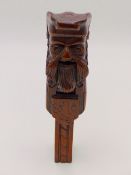 AN ANTIQUE CARVED OAK NUTCRACKER IN THE FORM OF A BEARDED GENTLEMAN.