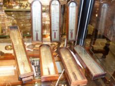 A GROUP OF SEVEN VARIOUS 19TH.C.MAHOGANY CASED THERMOMETERS WITH SILVERED SCALES.