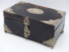 A WHITE METAL ESCUTCHEON CENTRE AND DECORATIVE BOUND CORNER TORTOISE SHELL HINGED BOX WITH