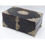 A WHITE METAL ESCUTCHEON CENTRE AND DECORATIVE BOUND CORNER TORTOISE SHELL HINGED BOX WITH