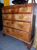 AN 18TH.C.WALNUT CHEST OF THREE SHORT AND THREE LONG DRAWERS ON BRACKET FEET. 98CMS WIDE.