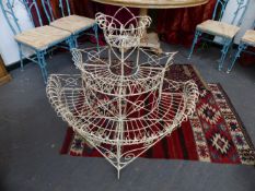 AN ANTIQUE WIREWORK THREE TIER DEMI LUNE PLANTSTAND.