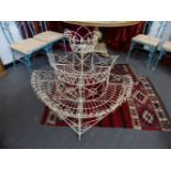 AN ANTIQUE WIREWORK THREE TIER DEMI LUNE PLANTSTAND.