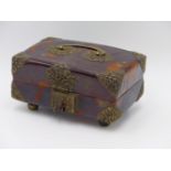 A FOOTED TORTOISE SHELL HINGED BOX WITH WHITE METAL BOUND CORNERS. MATCHING FLORAL HINGED HASP AND