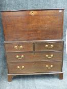 A LATE GEORGIAN OAK BLANKET BOX ON CHEST OF TWO SHORT AND TWO LONG DRAWERS STANDING ON BRACKET FEET.