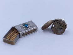 AN ART DECO SILVER MATCHBOX STRIKER WITH A HAMMERED FINISH AND AN ENAMELLED CENTRE MOTIF. DATED