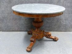 A CARVED MAHOGANY EMPIRE CENTRE TABLE WITH MOULDED EDGE GREY MARBLE TOP ON FLUTED URN PEDESTAL AND