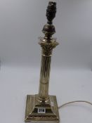 A SILVER TABLE LAMP OF NEO-CLASSICAL DESIGN WITH A REEDED COLUMN AND SQUARE PEDESTAL BASE.