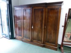 A VICTORIAN MAHOGANY GEORGIAN STYLE BREAKFRONT WARDROBE/LINEN PRESS, MOULDED CORNICE ABOVE FOUR FULL