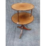 AN ANTIQUE MAHOGANY TWO TIER DUMB WAITER ON SABRE LEG TRIPOD BASE. DIA.64cms.