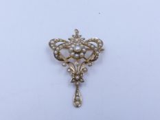 AN EARLY EDWARDIAN SEED PEARL BROOCH WITH ADDITIONAL PENDANT FITTING STAMPED 9ct GOLD.