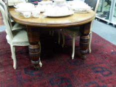 A VICTORIAN CARVED AND EBONISED WALNUT EXTENDING DINING TABLE, DEMI-LUNE SHAPE ENDS WITH TWO