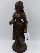 AN ANTIQUE BRONZE FIGURE OF A TUDOR LADY CARRYING A BOOK. H.38cms.