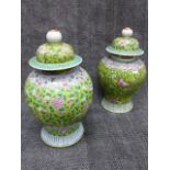 TWO SIMILAR CHINESE FAMILLE ROSE BALUSTER VASES WITH A PAIR OF ASSOCIATED DOME FORM COVERS.