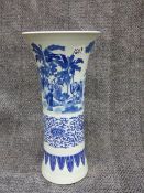 A CHINESE BLUE AND WHITE LARGE BEAKER FORM VASE DECORATED WITH FIGURES IN LANDSCAPE SETTINGS. H.