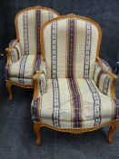 A PAIR OF FRENCH LOUIS XV STYLE ARMCHAIRS WITH MOULDED CARVED FRAMES AND CABRIOLE LEGS COVERED IN