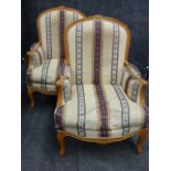 A PAIR OF FRENCH LOUIS XV STYLE ARMCHAIRS WITH MOULDED CARVED FRAMES AND CABRIOLE LEGS COVERED IN