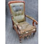 A CARVED MAHOGANY GENTLEMAN'S EARLY VICTORIAN LIBRARY ARMCHAIR IN GREEN LEATHER WITH BUTTONED BACK
