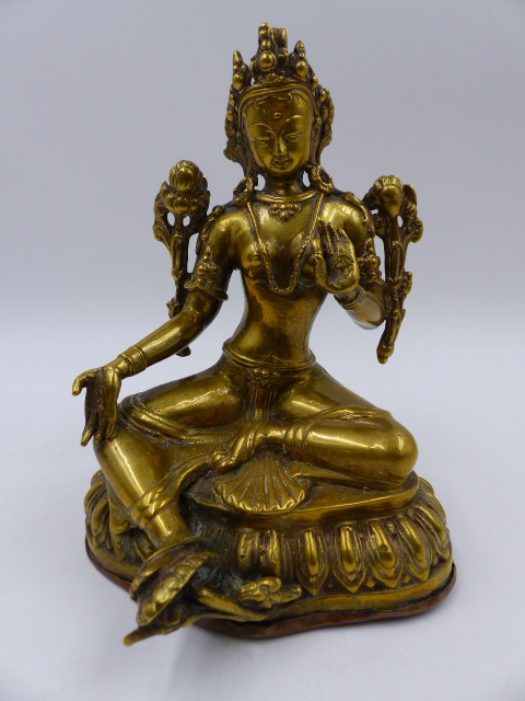 A TIBETAN GILT BRONZE AND COPPER FIGURE OF A SEATED DEITY. H.18cms.