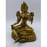 A TIBETAN GILT BRONZE AND COPPER FIGURE OF A SEATED DEITY. H.18cms.