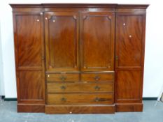 AN EARLY 19th.C.MAHOGANY LINEN PRESS COMPACTUM WARDROBE WITH PANEL DOORS ENCLOSING FIVE DEEP