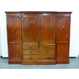 AN EARLY 19th.C.MAHOGANY LINEN PRESS COMPACTUM WARDROBE WITH PANEL DOORS ENCLOSING FIVE DEEP