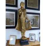 A CARVED GILTWOOD SOUTH EAST ASIAN FIGURE OF A BUDDHA WITH OVERALL VARI COLOURED MIRRORED INSETS