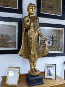 A CARVED GILTWOOD SOUTH EAST ASIAN FIGURE OF A BUDDHA WITH OVERALL VARI COLOURED MIRRORED INSETS