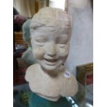 AN EARLY 20th.C. STUCCO PORTRAIT BUST OF A CHILD. H.34cms.