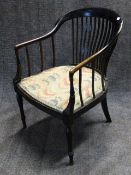 A LATE VICTORIAN EBONISED TUB FORM ARMCHAIR WITH RING TURNED TAPERED LEGS, STAMPED W.B. AND LABELLED