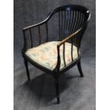 A LATE VICTORIAN EBONISED TUB FORM ARMCHAIR WITH RING TURNED TAPERED LEGS, STAMPED W.B. AND LABELLED